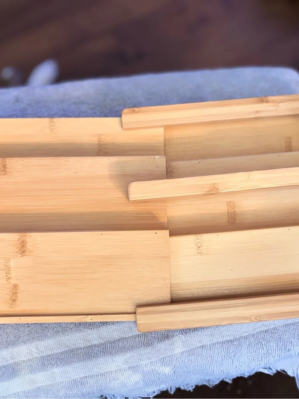 Bamboo 3 tiered expandable spice rack with natural wood grain.